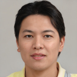 Joyful asian young-adult male with short  brown hair and brown eyes