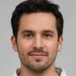 Joyful white young-adult male with short  brown hair and brown eyes