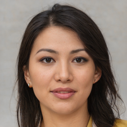 Joyful asian young-adult female with long  brown hair and brown eyes
