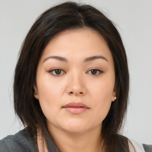 Neutral asian young-adult female with medium  brown hair and brown eyes