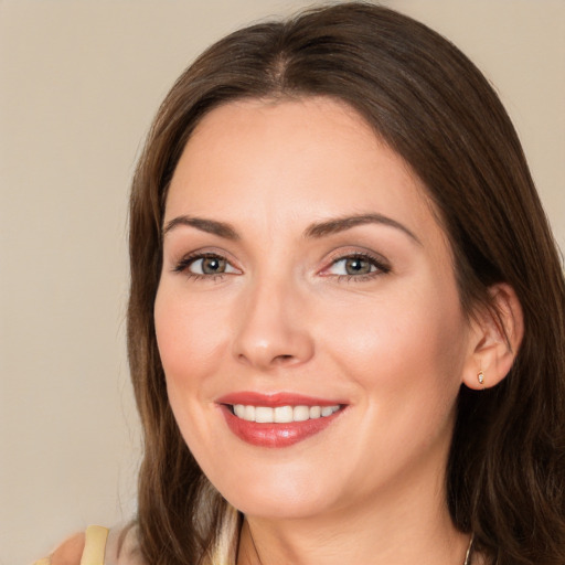 Joyful white young-adult female with long  brown hair and brown eyes