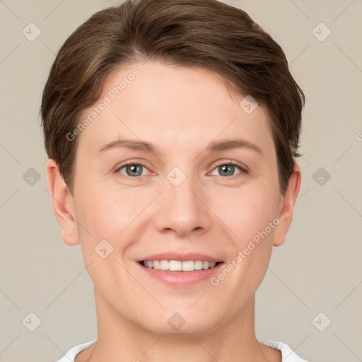 Joyful white young-adult female with short  brown hair and grey eyes