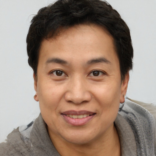 Joyful black adult male with short  brown hair and brown eyes