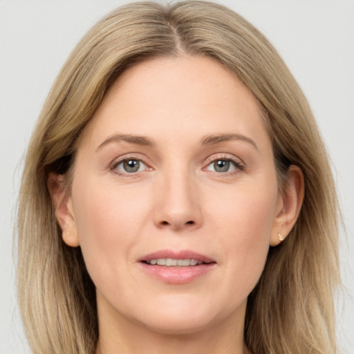 Joyful white adult female with long  brown hair and grey eyes