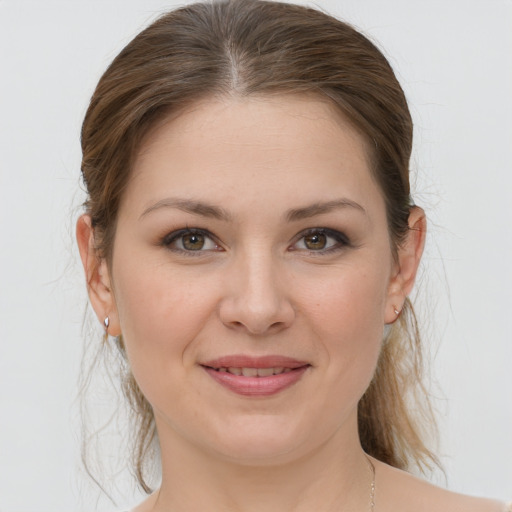 Joyful white young-adult female with medium  brown hair and grey eyes