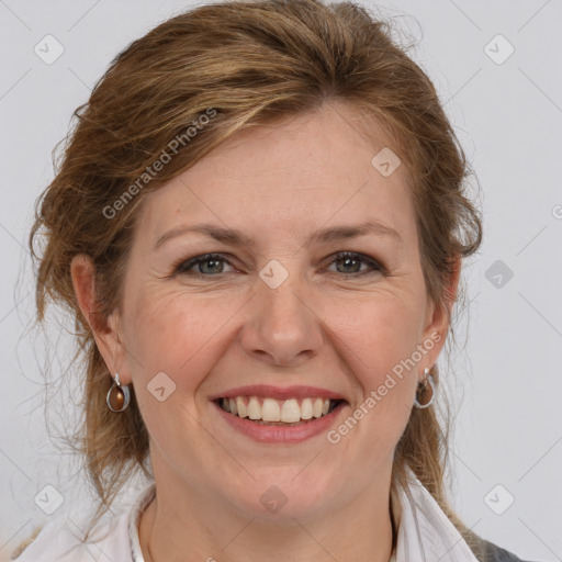 Joyful white adult female with medium  brown hair and grey eyes