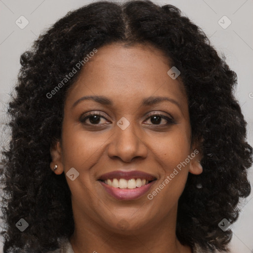 Joyful black young-adult female with long  brown hair and brown eyes