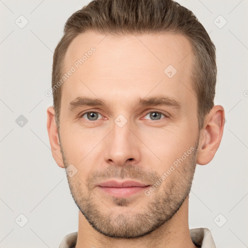 Joyful white young-adult male with short  brown hair and brown eyes