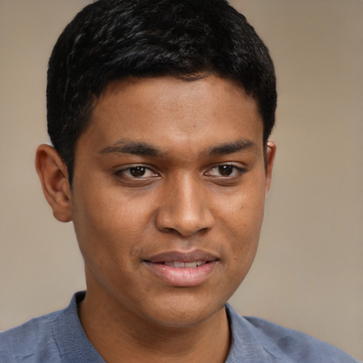 Joyful black young-adult male with short  brown hair and brown eyes