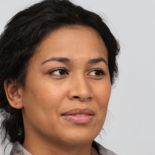 Joyful latino adult female with medium  brown hair and brown eyes