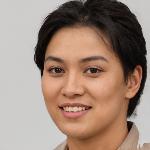 Joyful asian young-adult female with medium  brown hair and brown eyes