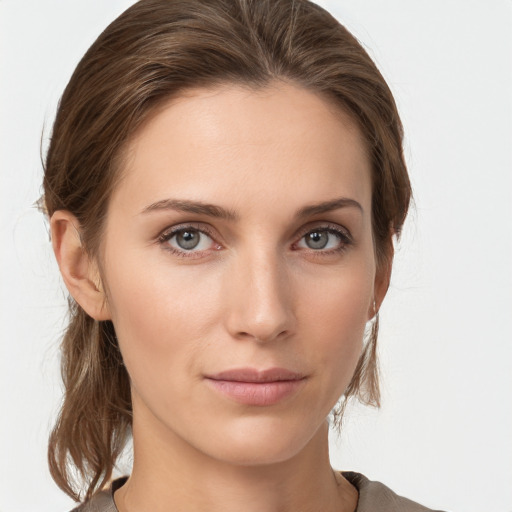 Joyful white young-adult female with medium  brown hair and grey eyes