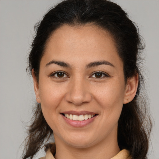 Joyful white young-adult female with medium  brown hair and brown eyes