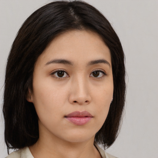 Neutral asian young-adult female with medium  brown hair and brown eyes