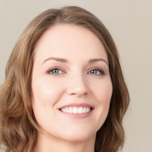 Joyful white young-adult female with medium  brown hair and green eyes