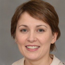 Joyful white adult female with medium  brown hair and grey eyes