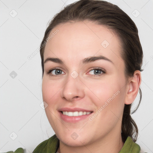 Joyful white young-adult female with medium  brown hair and grey eyes