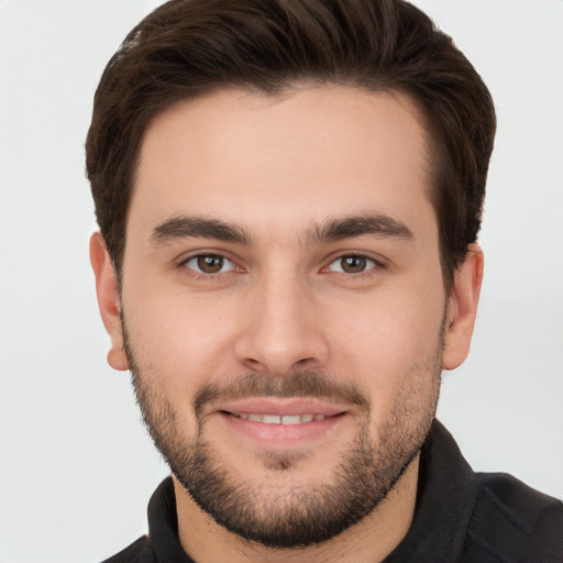 Joyful white young-adult male with short  brown hair and brown eyes