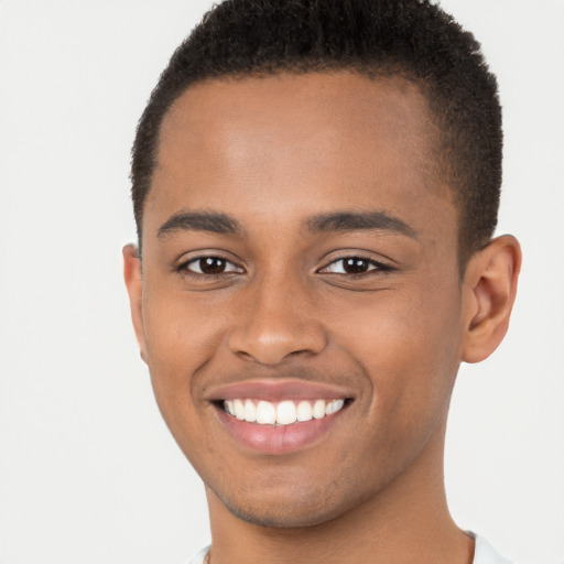 Joyful black young-adult male with short  brown hair and brown eyes