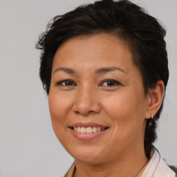 Joyful white adult female with medium  brown hair and brown eyes