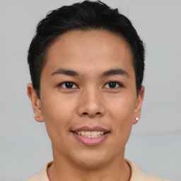 Joyful asian young-adult male with short  black hair and brown eyes