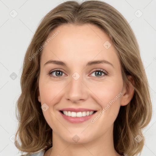 Joyful white young-adult female with long  brown hair and green eyes