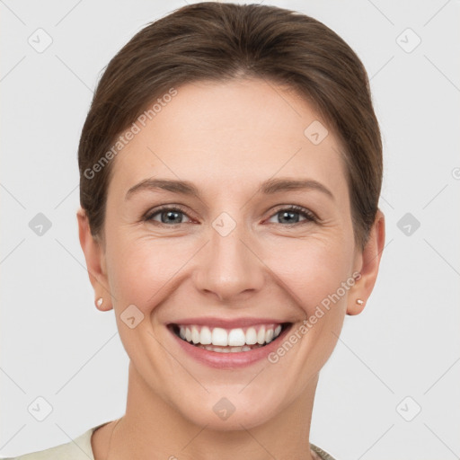 Joyful white young-adult female with short  brown hair and grey eyes