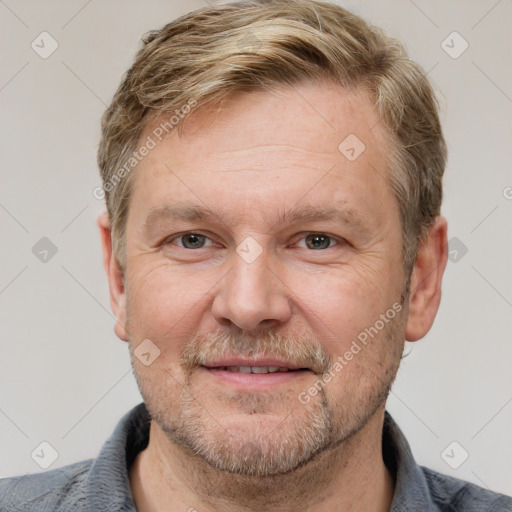 Joyful white adult male with short  brown hair and grey eyes