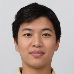 Joyful asian young-adult male with short  brown hair and brown eyes