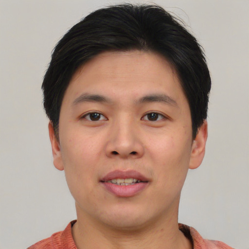 Joyful asian young-adult male with short  brown hair and brown eyes