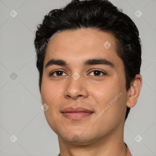 Joyful white young-adult male with short  black hair and brown eyes