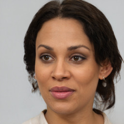 Joyful black adult female with medium  brown hair and brown eyes