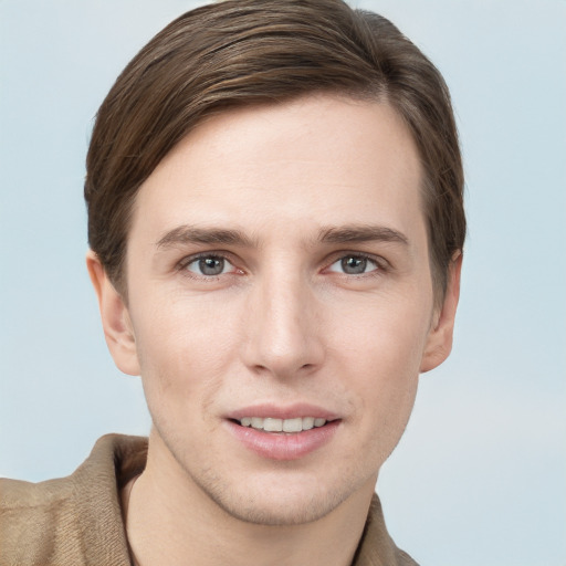 Joyful white young-adult male with short  brown hair and grey eyes