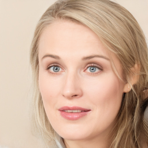 Joyful white young-adult female with long  brown hair and blue eyes