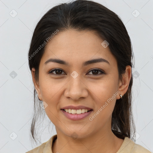 Joyful latino young-adult female with medium  brown hair and brown eyes