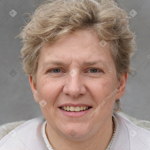 Joyful white adult female with short  brown hair and grey eyes