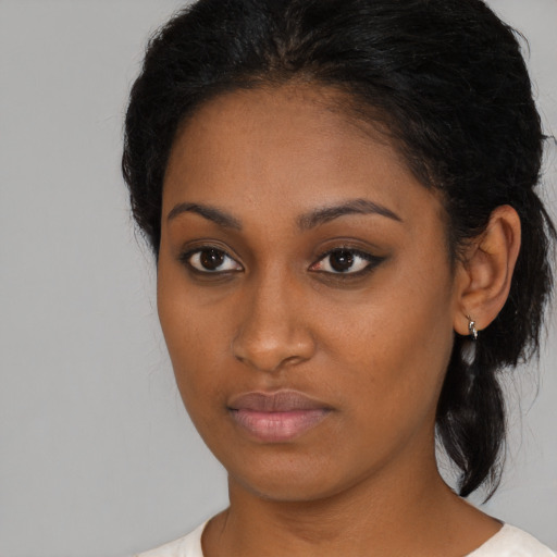Neutral black young-adult female with medium  brown hair and brown eyes