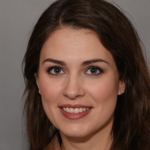 Joyful white young-adult female with long  brown hair and brown eyes