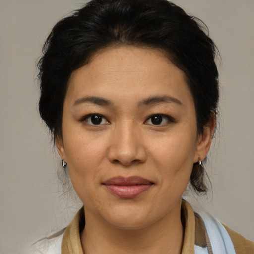 Joyful asian adult female with medium  brown hair and brown eyes