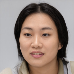 Joyful asian young-adult female with medium  black hair and brown eyes