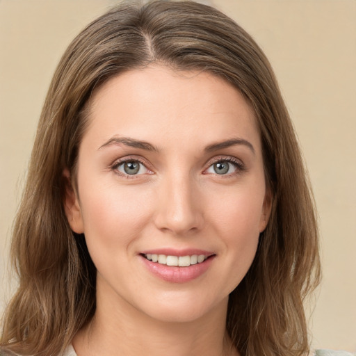 Joyful white young-adult female with medium  brown hair and green eyes