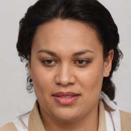 Joyful latino adult female with medium  brown hair and brown eyes