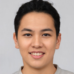 Joyful asian young-adult male with short  black hair and brown eyes