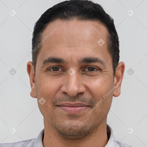 Joyful latino young-adult male with short  black hair and brown eyes