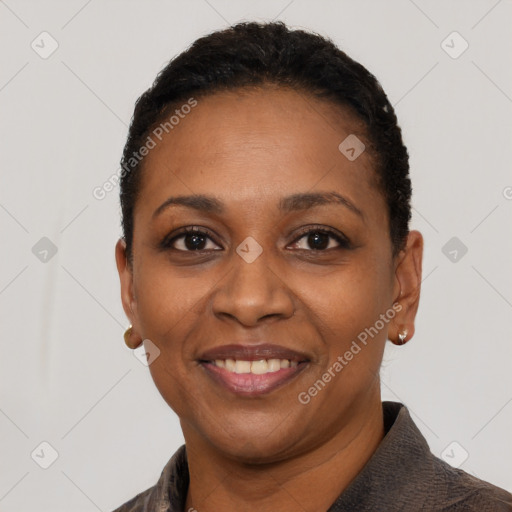 Joyful black young-adult female with short  black hair and brown eyes