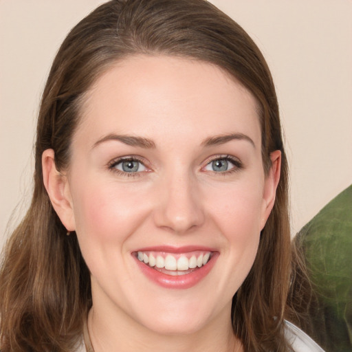 Joyful white young-adult female with long  brown hair and grey eyes