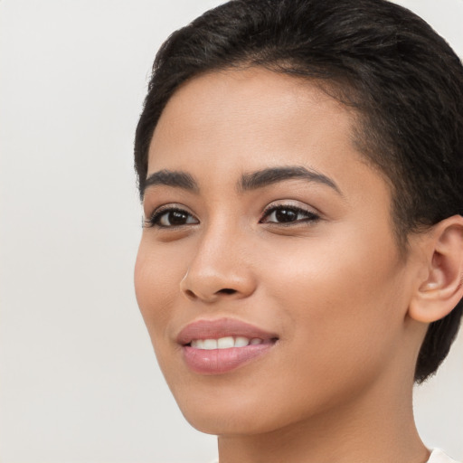 Joyful latino young-adult female with short  brown hair and brown eyes