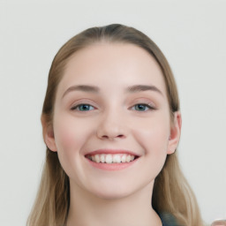 Joyful white young-adult female with long  brown hair and blue eyes