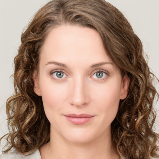 Joyful white young-adult female with medium  brown hair and green eyes