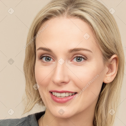 Joyful white young-adult female with long  brown hair and blue eyes